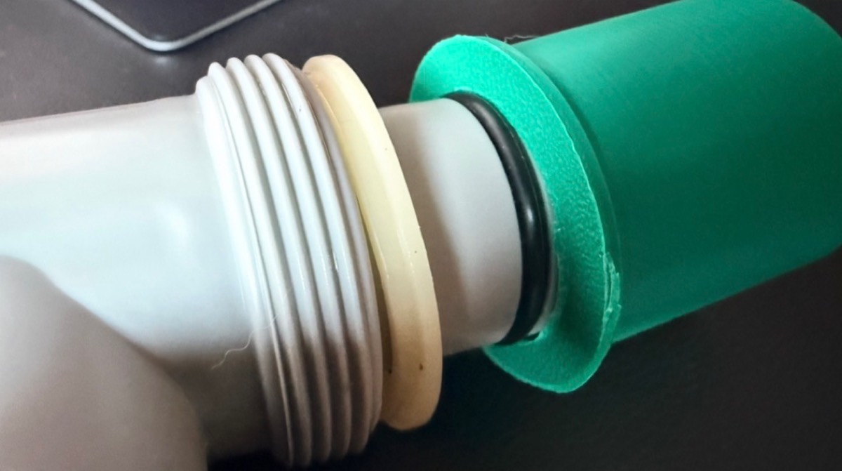 The adapter shoulder against the threaded wall outlet, with its O-ring