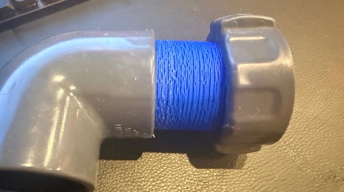 The adapter joining the PVC elbow to the union nut